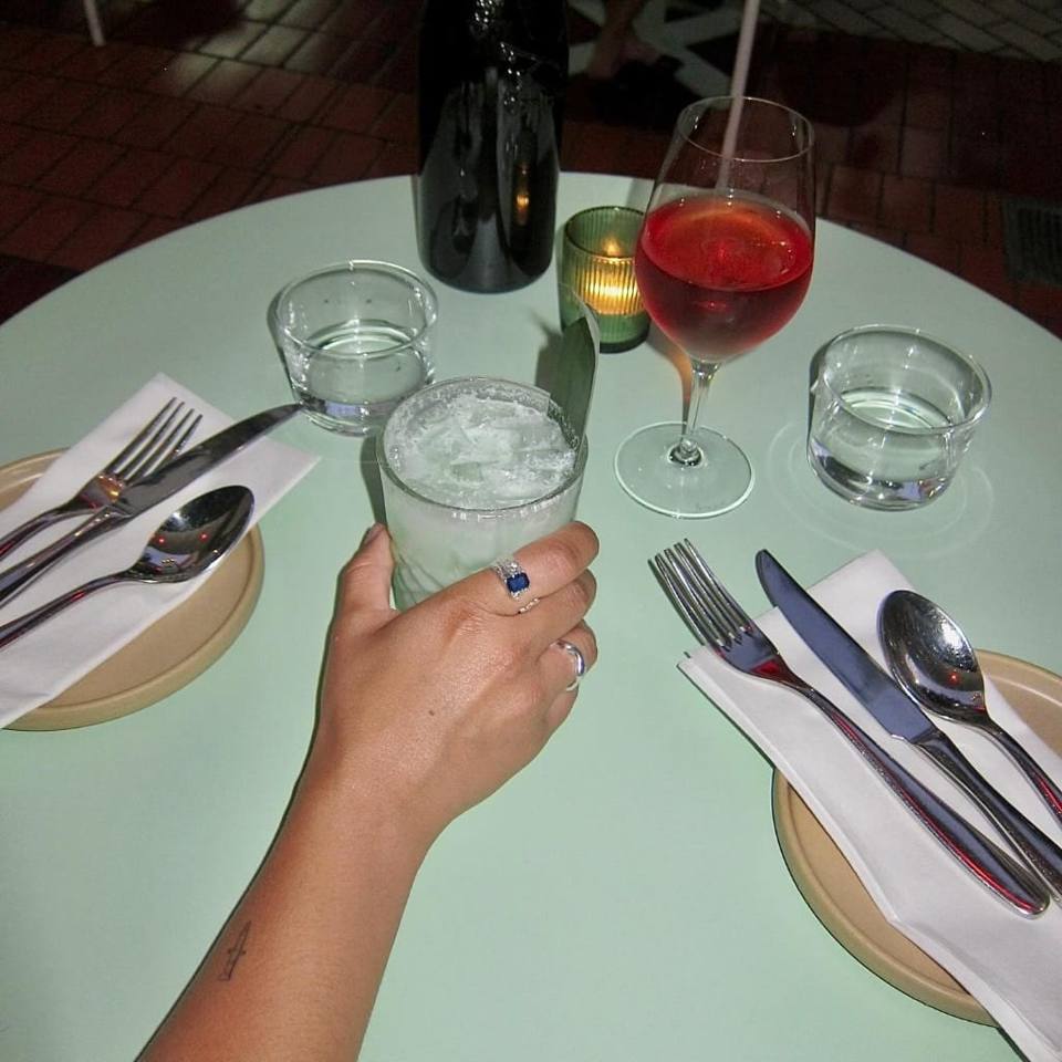 A colourful restaurant table set with cocktails at Boodle Fight